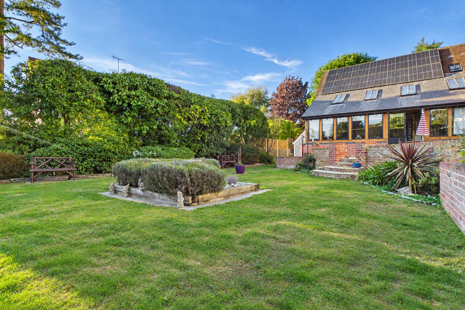 Lush Suburban Garden Under Blue Skies.png